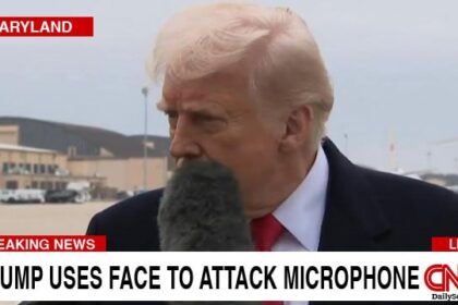 CNN news reporter's microphone hitting Donald Trump in the face.