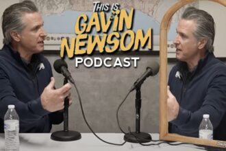 Gavin Newsom interviewing himself in a mirror on his new This is Gavin Newsom podcast.