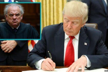 Donald Trump signing an executive order that was ruled by a federal judge.