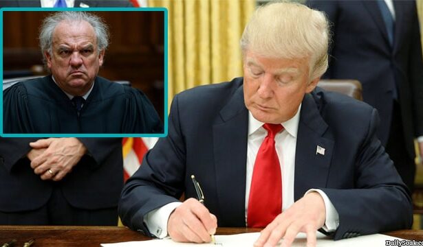 Donald Trump signing an executive order that was ruled by a federal judge.