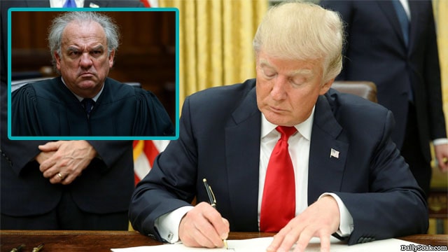 Donald Trump signing an executive order that was ruled by a federal judge.