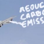 Bernie Sanders private jet in sky contrails spelling out word "Reduce Carbon Emissions."