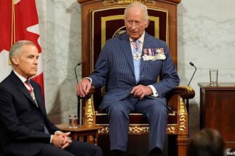 Mark Carney sitting at the feet of King Charles in Canada.