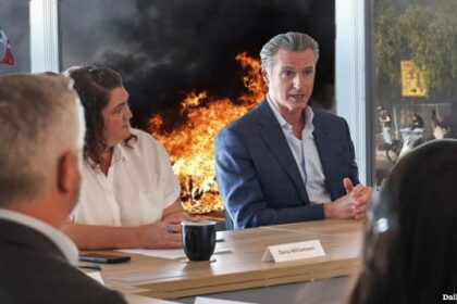 Gavin Newsom holding a meeting discussing Trump as the LA riots rage behind him.