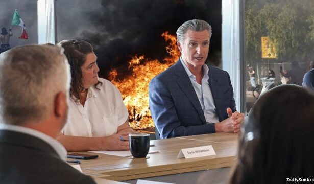 Gavin Newsom holding a meeting discussing Trump as the LA riots rage behind him.