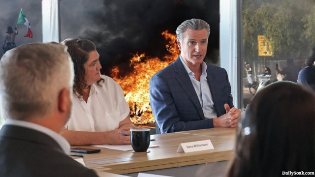 Gavin Newsom holding a meeting discussing Trump as the LA riots rage behind him.