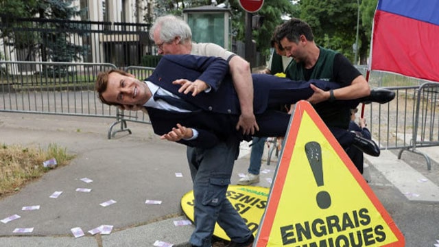 Wax statue of French President Emmanuel Macron being stolen by Greenpeace activists.