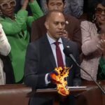 Democrat Hakeem Jeffries hand catches fire after touching Constitution inside Congress.