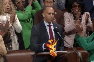 Democrat Hakeem Jeffries hand catches fire after touching Constitution inside Congress.