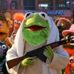 Kermit the Frog wearing Muslim clothing standing in front of the other Muppets.