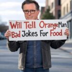 Late Show host Stephen Colbert standing on street corner holding a sign.