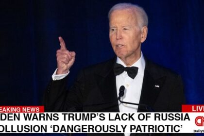 Joe Biden giving a speech on stage regarding Donald Trump's alleged Russia collusion.