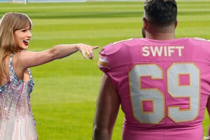Travis Kelsey wearing a football jersey as Taylor Swift points and laughs at him.