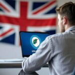 UK British man looking at laptop.
