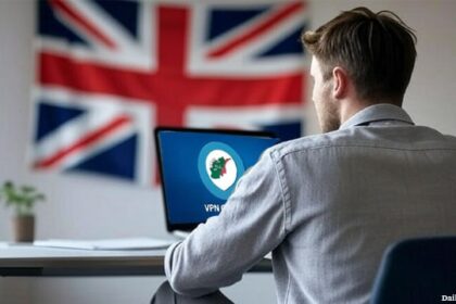 UK British man looking at laptop.
