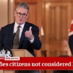 UK Prime Minister Keir Starmer giving a speech behind a podium on stage.