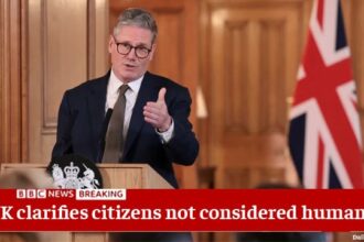 UK Prime Minister Keir Starmer giving a speech behind a podium on stage.