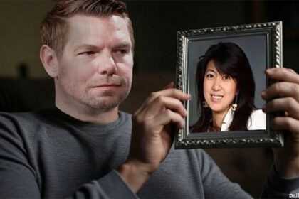 Male California Democrat Eric Swalwell sitting on a couch staring a picture frame with Asian woman Fang Fang in it.