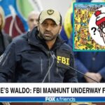 FBI Director Kash Patel speaking in front of a podium on the Where's Waldo character.