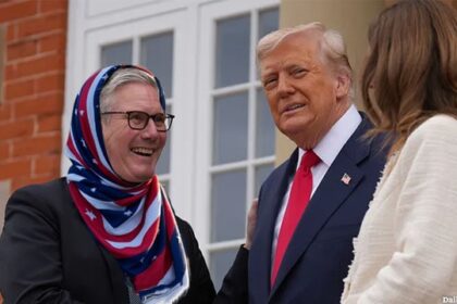 UK Prime Minister Keir Starmer wearing an American flag Islamic hijab as he shakes the hand of President Donald Trump.