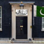 UK Prime Minister's office on 10 Downing Street with a green Pakistan flag in front.