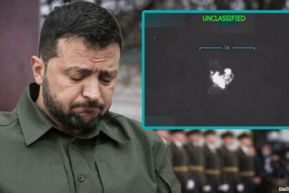 Ukraine President Zelensky with his head down in mourning in front of soldiers.