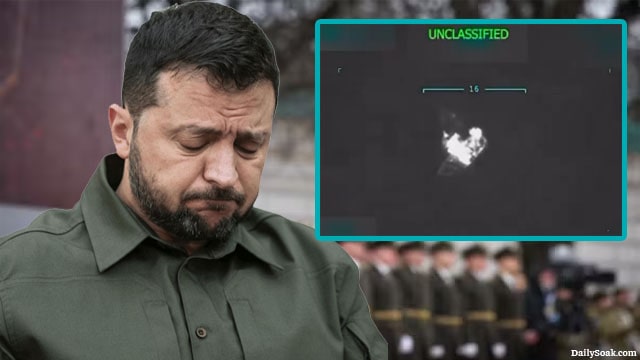 Ukraine President Zelensky with his head down in mourning in front of soldiers.