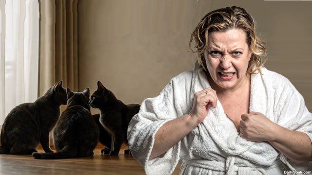 Crazy, liberal white woman standing in a room with numerous black cats.