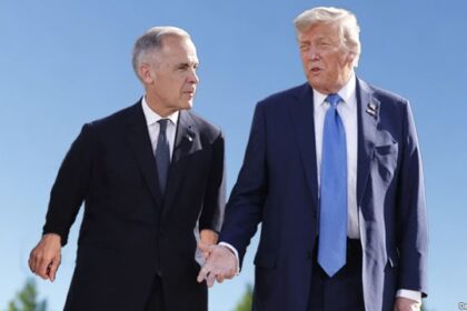 Mark Carney and Donald Trump standing at the White House during meeting.