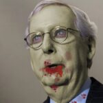 Congress Senator Mitch McConnell with blood dripping from his mouth dressed as a zombie for Halloween.