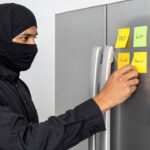 Islamic terrorist leaving a Post-It sticky note on a refrigerator.