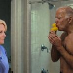 Jill Biden watching Joe Biden take a shower with his yellow rubber ducky.