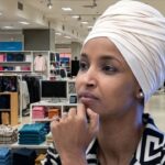 Ilhan Omar wearing a hijab inside of a department store looking for gifts for brother.