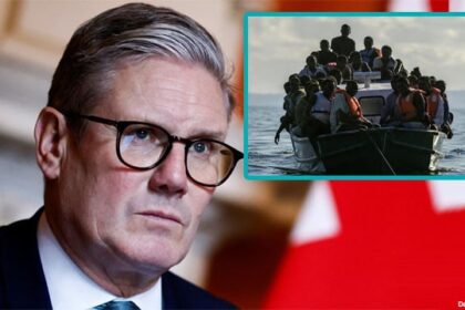 UK Prime Minister Keir Starmer scowling at illegal African migrants on a boat.