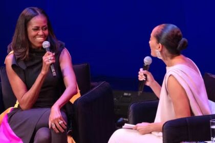 Michelle Obama on stage during an interview with another black woman.
