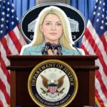 Cardboard cutout of Attorney General Pam Bondi standing behind a podium.