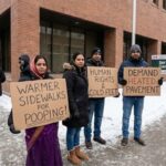 Indian immigrants in Canada protesting in front of government building.