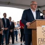 Democrats Tim Walz and Ilhan Omar on stage speaking behind a podium in Minnesota on Somali daycare fraud.