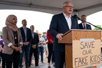 Democrats Tim Walz and Ilhan Omar on stage speaking behind a podium in Minnesota on Somali daycare fraud.
