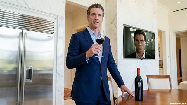 California Governor Gavin Newsom drinking wine inside of his mansion.