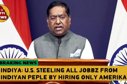 India official giving speech at podium regarding Indian H-1b visas.