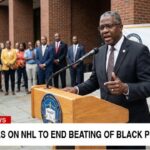 NAACP black man behind podium giving speech on NHL.