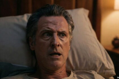Gavin Newsom in bed waking up petrified from a nightmare.