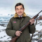 UK British character Mr. Bean wearing a parka and holding a gun in Greenland.