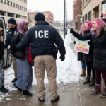 ICE agents arresting Somalis in Minnesota as white female protesters scream at them.