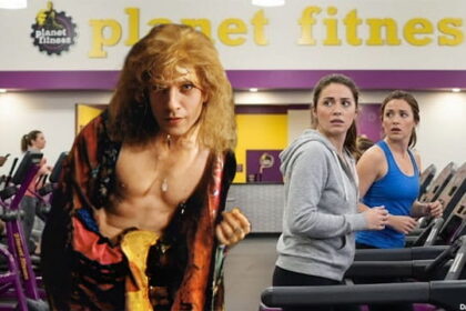 Transgender serial killer Buffalo Bill standing in front of a Planet Fitness gym.
