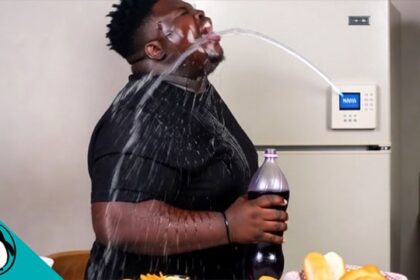 Fat black man with water being shot at his face by an RFK Jr. smart refrigerator.