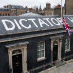 "Dicatato Here" painted in white paint on the roof of the British Prime Minister's office.