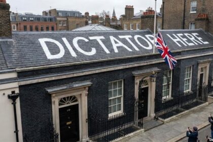 "Dicatato Here" painted in white paint on the roof of the British Prime Minister's office.