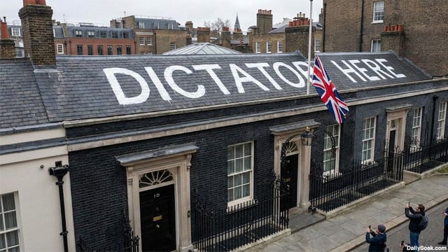 "Dicatato Here" painted in white paint on the roof of the British Prime Minister's office.